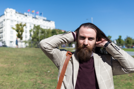 Businessman combing his Hair on the Street in Madrid Train Stationの写真素材