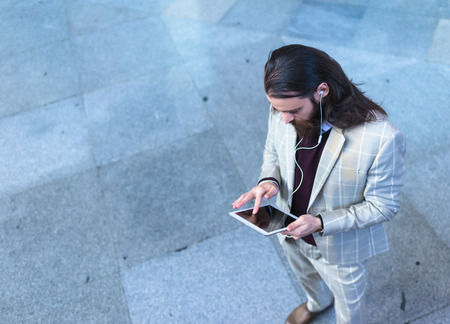 Man calling with his Tablet in Madrid Train Stationの写真素材
