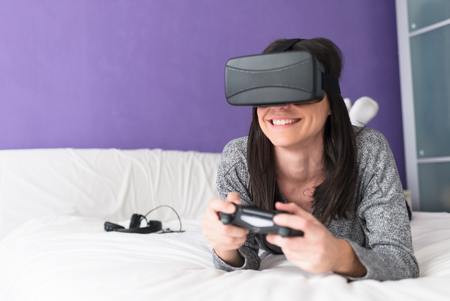 Enjoying a day playing on her Bedの写真素材