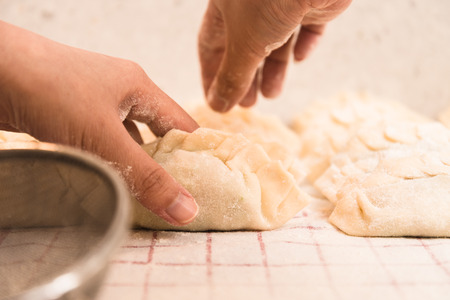 Adding a bit of Flour onto Homemade Dumplings.の写真素材