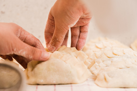 Women Hands working in Homemade Dumplings.の写真素材