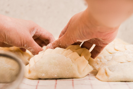 Women Hands preparing Dumplings at Homeの写真素材