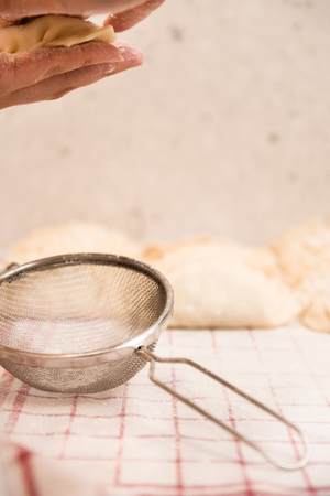 Strainer, Hands and Dumpling: Homemade Dim Sum preparing at Home.の写真素材
