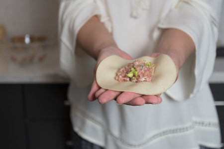 Female Hands showing the Core of a Homemade Dumplingの写真素材