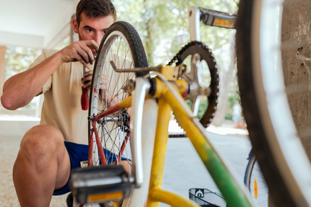 Man checking his Bike Wheel after being reparedの写真素材
