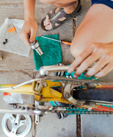 Reparing his Old Vintage Bikeの写真素材