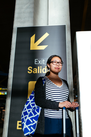 Asian woman in a shadow area in the airportの写真素材