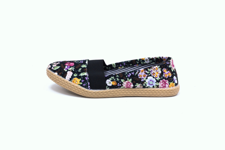 Ladies flat floral shoes on white backgroundの写真素材