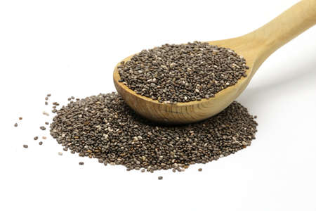Chia seeds in a wooden spoon on white isolated backgroundの写真素材