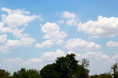 beautiful white cloudy on blue sky background at noon in Thailandの写真素材