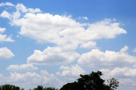 beautiful white cloudy on blue sky background at noon in Thailandの写真素材