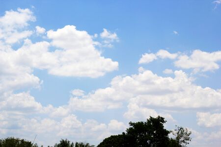 beautiful white cloudy on blue sky background at noon in Thailandの写真素材