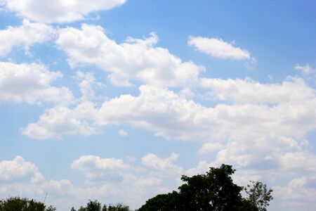 beautiful white cloudy on blue sky background at noon in Thailandの写真素材