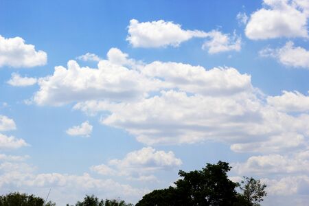 beautiful white cloudy on blue sky background at noon in Thailandの写真素材