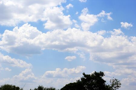 beautiful white cloudy on blue sky background at noon in Thailandの写真素材