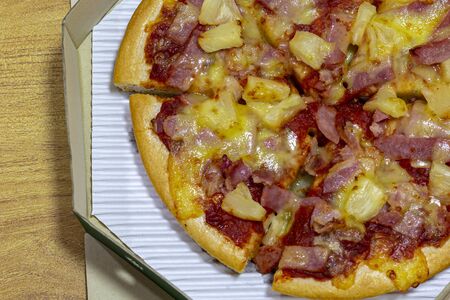 Pizza Ham and cheese in a box on the wood tableの写真素材