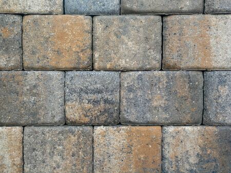 Bricks, paving stones, stacked as a wall, as a background.