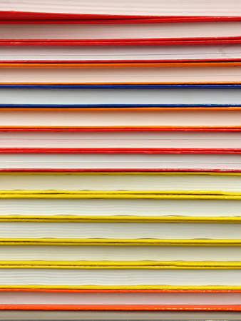 Exercise books stacked different colors horizontallyの写真素材