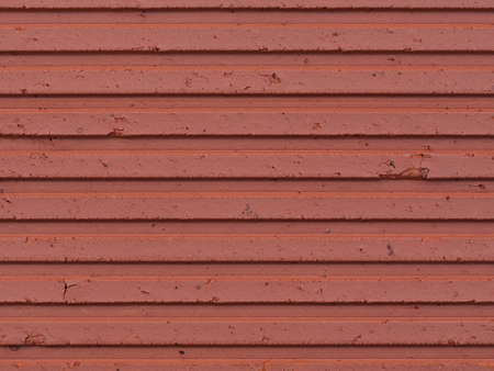 Red stone cement wall with a horizontal groove structureの写真素材