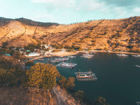 Aerial view of traditional fisherman boat anchored in small cove in Bima, Indonesia