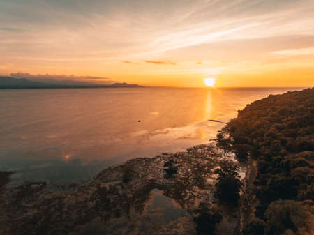 Sunset in low tide beach captured with droneの写真素材