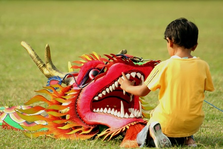 A Little Girl with a Red Dragon Head Kiteの写真素材