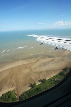 An air plane window view of a beautiful beach and seaの写真素材