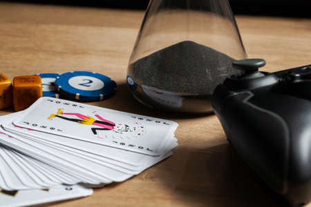 Games night staying in with friends background poker chips dice & cards video games controller on...