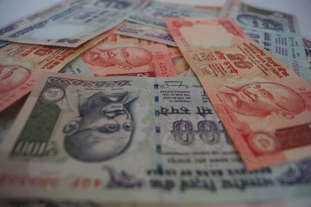 Indian passport with currency as backgroundの写真素材