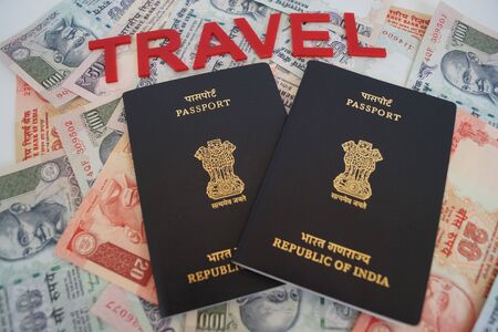 Indian passport with currency as backgroundの写真素材