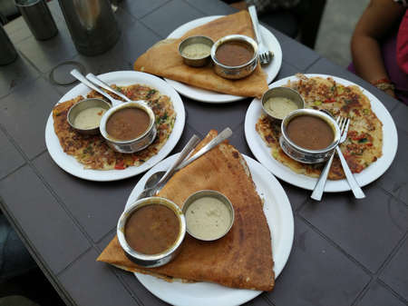 South indian breakfast for a group of people. Dosa and utpam for a family.の写真素材