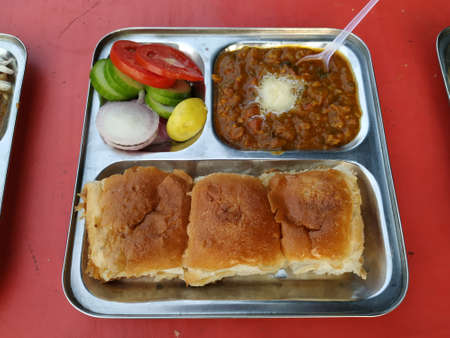 Pav Bhaji- Street food of Maharastra, India. Spicy curry with bread and salad.の写真素材