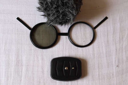 Creative human face artwork looking like a cartoon with glasses, hairs and mouth. Black and white human face made with camera objects.の写真素材