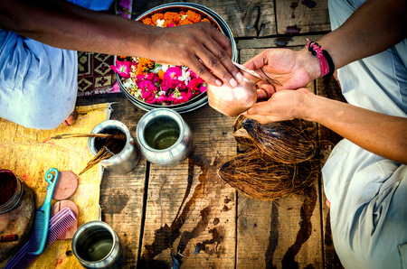 performing prayer pooja hindu indian way sittingの写真素材