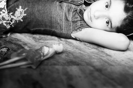 portrait of small girl with her dollの写真素材