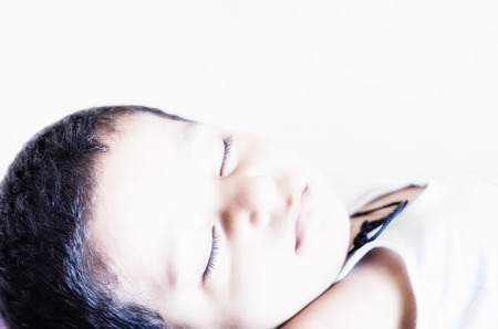high key protrait of small baby child sleeping