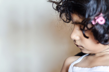 child, alone, lonliness, solitude, sad, portrait, sideview, female, lifestyle, close up, candid, indian, asian, 5 year, looking left, indoor, horizontal, copyspace, copy ready, disturbed, calmness,の写真素材