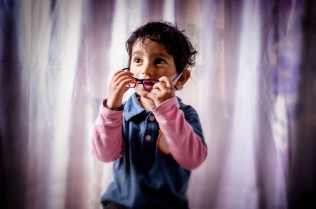 Portrait of asian Indian boy child smiling wearing eye glassの写真素材