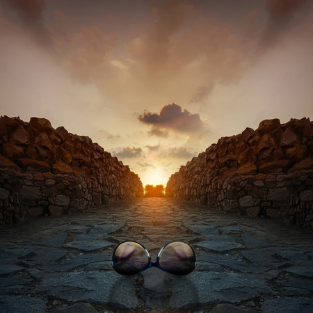 Sunglasses on rocks at beautiful Sunset sunrise at Qutub Minar New Delhi indiaの写真素材