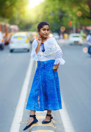 Indian Asian Fashion Model Girl Portrait posing on City Roads with dreamy magical bokeh backgroundの写真素材
