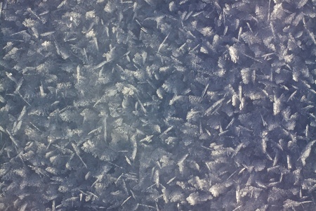 Type of snow common on sunny hills when the top layer melts on the sun and then freezes againの写真素材