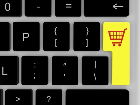 Symbol of shopping trolley on yellow key on keyboardの写真素材