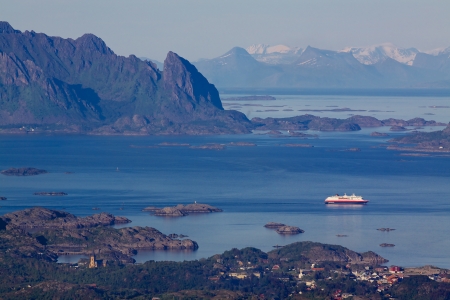 Large cruising ship leaving town of Svolvaer on Lofoten islands in norway with scenic panoramaのeditorial素材