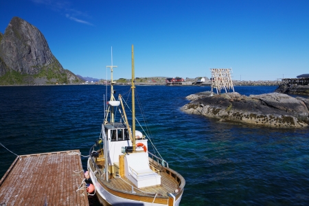 Traditional fishing boat in scenic harbor on Lofoten islands in Norway