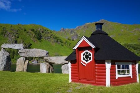 Picturesque red shed on scenic Lofoten islands on sunny summer dayの写真素材