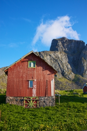 Traditional norwegian shed under the cliffs on island of Vaeroy, Lofoten, Norwayのeditorial素材