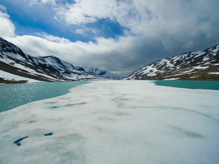 Ice on frozen lake in norwegian mountains on Gamle Strynefjellsvegen mountain passの写真素材