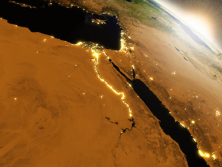 Egypt with surrounding region during sunrise as seen from Earth's orbit in space. 3D illustration with highly detailed realistic planet surface, clouds and city lights.の写真素材