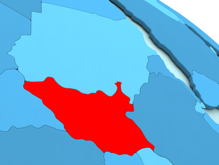 3D illustration of South Sudan highlighted in red color on blue globeの写真素材