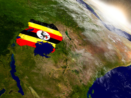 Uganda with embedded flag on planet surface during sunrise. 3D illustration with highly detailed realistic planet surface and visible city lights. Elements of this image furnished by NASA.の写真素材